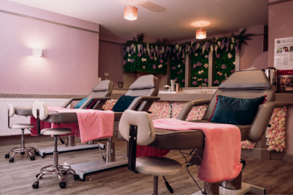 Grey massage therapy beds inside Foundations beauty academy